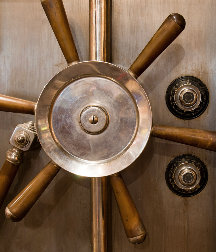 Vault door wheel and locks, typically seen on a bank