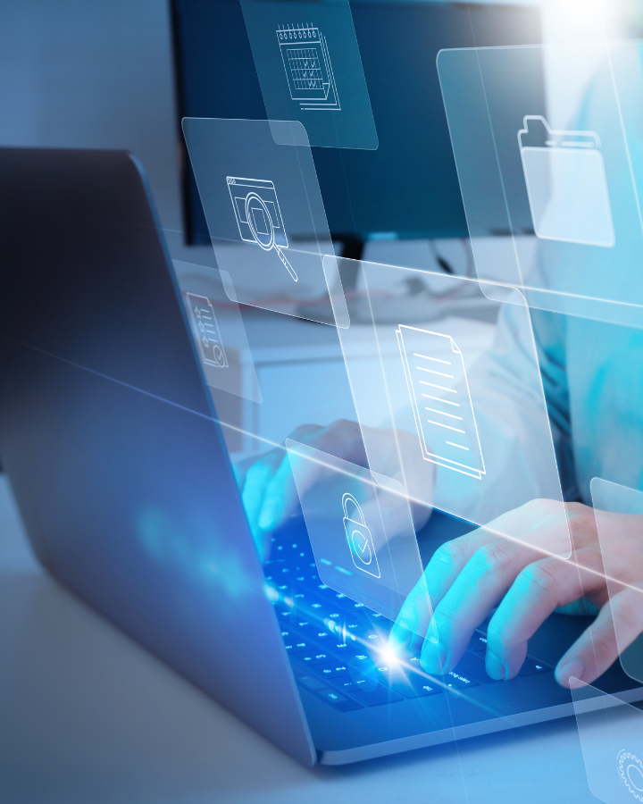 background image of hands typing on a laptop