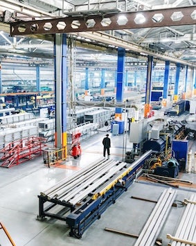 Overhead view of a busy factory floor with machinery and workers, showcasing industrial activity