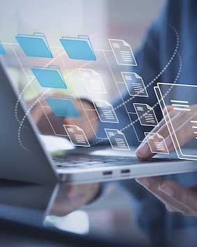 Image showing hands typing on a laptop with a virtual file system overlay